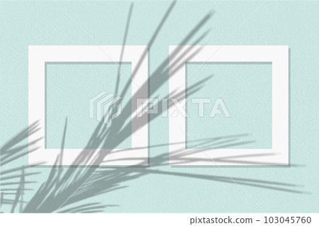 Natural light casts shadows from the palm branch on 2 square frames of white paper lying on a blue facture background. Mock up with an overlay of plant shadows Natural light casts shadows from the palm branch on 2 square frames of white paper lying on a blue facture background. Mock up with an overlay of plant shadows 103045760
