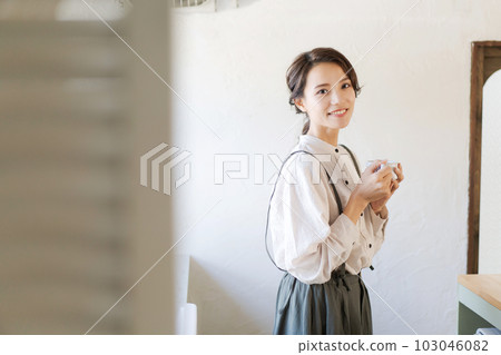 Portrait of a woman drinking a hot drink Portrait of a woman drinking a hot drink 103046082