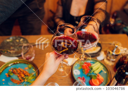 Clinking glasses with alcohol and toasting, party. 103046786