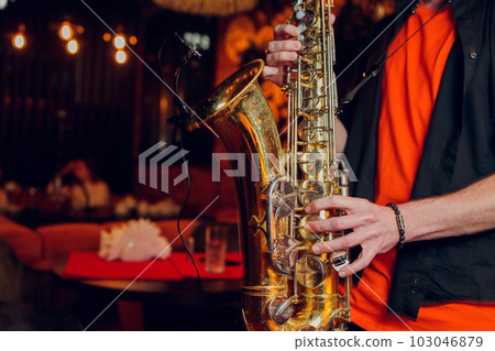International jazz day and World Jazz festival. Saxophone, music instrument played by saxophonist player musician in fest. International jazz day and World Jazz festival. Saxophone, music instrument played by saxophonist player musician in fest. 103046879