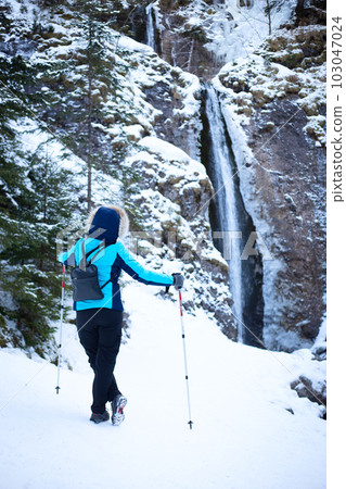 Hiking woman on mountain waterfall background 103047024