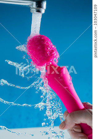 A woman washes a pink vibrator under running... - Stock Photo [103047109] -  PIXTA