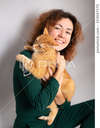 Red cat and his pretty young woman 103047370