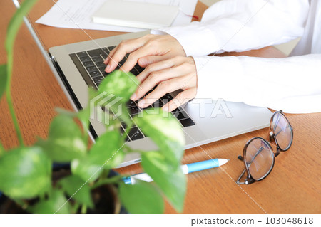 hands working on a laptop hands working on a laptop 103048618