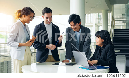 Multinational business group talking in lobby 103051302