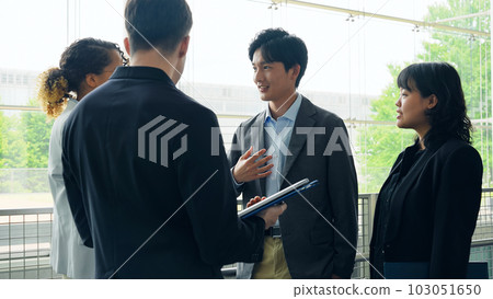 Multinational business group talking in lobby 103051650