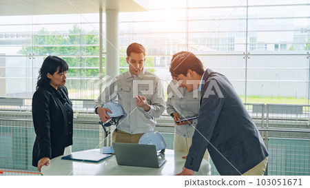 Group of multinational engineers and business people meeting in a building Group of multinational engineers and business people meeting in a building 103051671