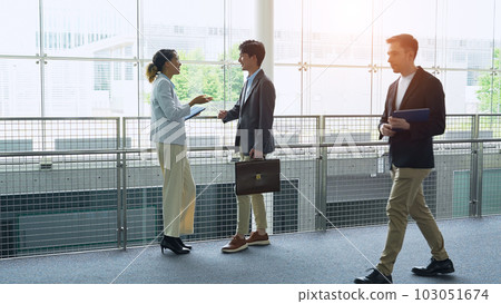 Multinational business group talking in lobby 103051674