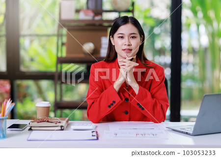 Concept of business office woman working,Businesswoman smile while working about her invesment plan with analyzing document and business investment graph data by using laptop on desk in workstation. Concept of business office woman working,Businesswoman smile while working about her invesment plan with analyzing document and business investment graph data by using laptop on desk in workstation. 103053233