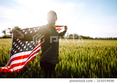 Man hold waving american USA flag. Patriot raise national american flag. Independence Day, 4th July. 103054696