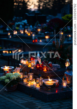 Candle flames illuminating on Polish cemetery 103054792
