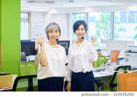 Female operator with headset working in the office Female operator with headset working in the office 103056260