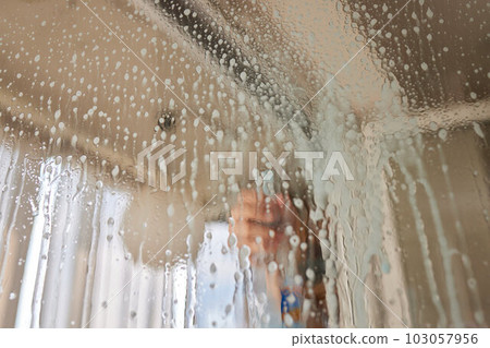 Woman cleaning window at home, closeup. Household chores. Woman cleaning window at home, closeup. Household chores. 103057956