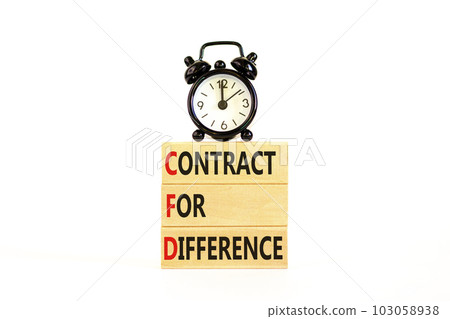 CFD symbol. Concept words CFD contract of difference on beautiful wooden block. Black alarm clock. Beautiful white table white background. Business and CFD contract of difference concept. Copy space. 103058938