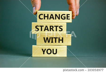 Change starts with you symbol. Concept words Change starts with you on wooden blocks on a beautiful grey table grey background. Businessman hand. Business motivational change starts with you concept. 103058977
