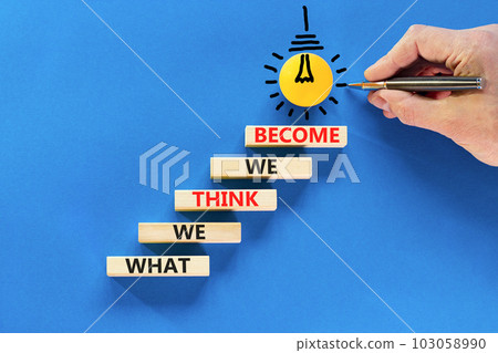 We become or think symbol. Concept word What we think We become on wooden block. Beautiful blue table blue background. Businessman hand. Business we become or think concept. Copy space. We become or think symbol. Concept word What we think We become on wooden block. Beautiful blue table blue background. Businessman hand. Business we become or think concept. Copy space. 103058990