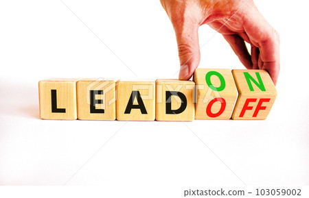 Lead on or off symbol. Businessman turns wooden cubes and changes word Lead off to Lead on. Beautiful white table white background. Business and lead on or off concept. Copy space. Lead on or off symbol. Businessman turns wooden cubes and changes word Lead off to Lead on. Beautiful white table white background. Business and lead on or off concept. Copy space. 103059002