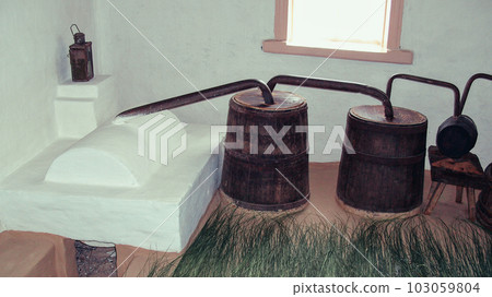 An old Ukrainian moonshine machine. Equipment for the production of homemade strong alcohol. Moonshine brewing. 103059804