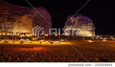 Illuminated outdoor lounge in front of elephant rock erosion monolith standing in the night desert, Al Ula, Saudi Arabia Illuminated outdoor lounge in front of elephant rock erosion monolith standing in the night desert, Al Ula, Saudi Arabia 103059948