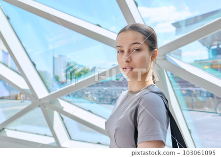 Portrait of teenage girl inside modern building, urban city background 103061095