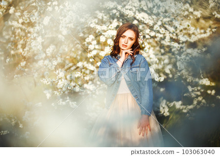 Portrait of a beautiful bride. Wedding concept. Stylish wedding. Great sunset light. Spring garden. 103063040