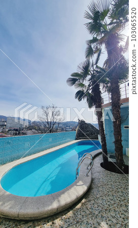 a swimming pool in the courtyard of a house on a mountain or in a mini hotel. 103065520