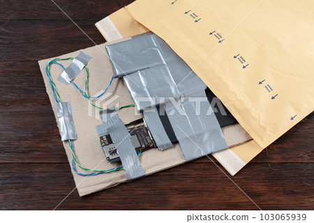 Mail bomb. Improvised Explosive Device with plastic explosive C-4 and cell phone module in envelope Mail bomb. Improvised Explosive Device with plastic explosive C-4 and cell phone module in envelope 103065939