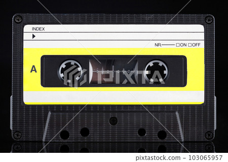 Yellow labeled retro vintage compact cassette A - side on black Yellow labeled retro vintage compact cassette A - side on black 103065957