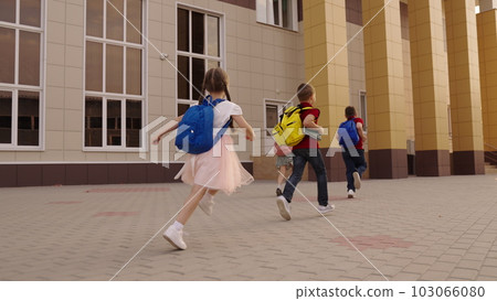 small children with school backpacks run. child running way school class for lesson. school bag shoulders child. childre group run. teamwork. team small children play before lesson school yard. boy small children with school backpacks run. child running way school class for lesson. school bag shoulders child. childre group run. teamwork. team small children play before lesson school yard. boy 103066080