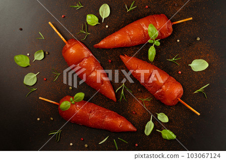 Fresh raw marinated chicken meat skewers iner fillet on a black background.Top view.Copy space. Fresh raw marinated chicken meat skewers iner fillet on a black background.Top view.Copy space. 103067124