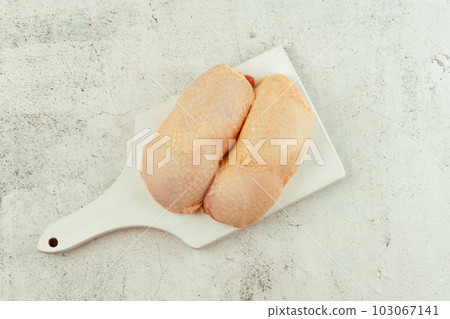 Raw fresh chicken leg meat with skin on a light background.Copy space.Food for retail.Procurement for designers.Ogranic food,healthy eating.Food concept.Top view.Chicken leg meat. Raw fresh chicken leg meat with skin on a light background.Copy space.Food for retail.Procurement for designers.Ogranic food,healthy eating.Food concept.Top view.Chicken leg meat. 103067141