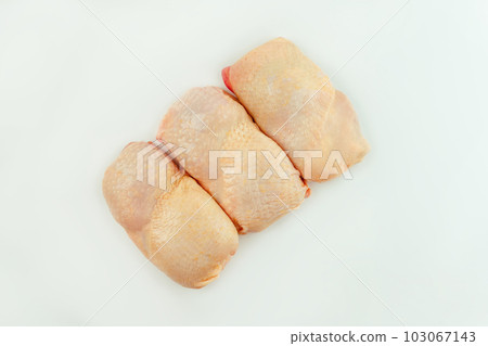 Raw fresh chicken leg meat with skin on white background.Copy space.Food for retail.Procurement for designers.Ogranic food,healthy eating.Food concept.Top view.Chicken leg meat. 103067143