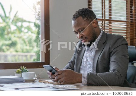 businessman reading an email on smartphone and Social media while working in office businessman reading an email on smartphone and Social media while working in office 103068685