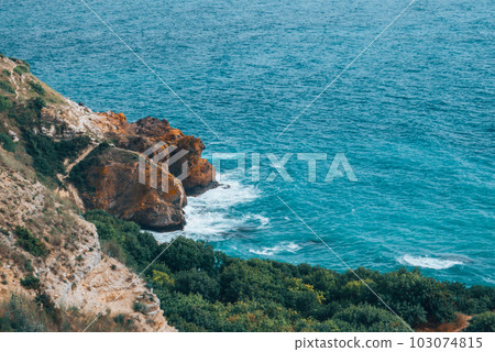View from the mountain to the waves of the sea. View from the mountain to the waves of the sea. 103074815