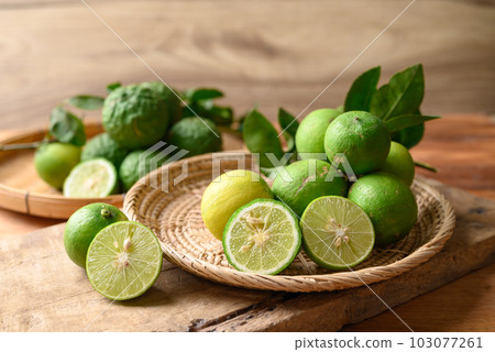 Kaffir lime and lime fruit on wooden background 103077261