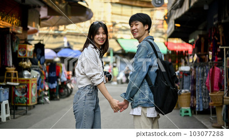 A tourist couple holding hands while sightseeing the Chiang Mai old town A tourist couple holding hands while sightseeing the Chiang Mai old town 103077288