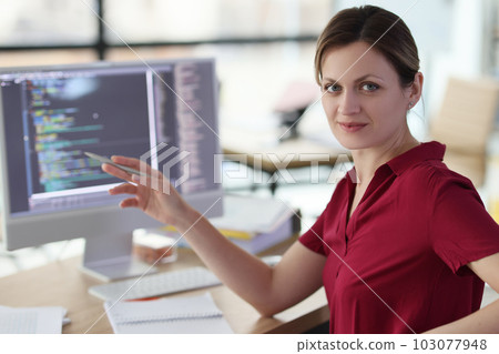 Woman shows with pen on complex code developing software Woman shows with pen on complex code developing software 103077948