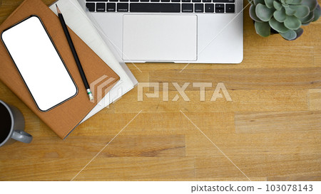 Workspace top view with laptop, smartphone mockup, and copy space on wooden tabletop. Workspace top view with laptop, smartphone mockup, and copy space on wooden tabletop. 103078143