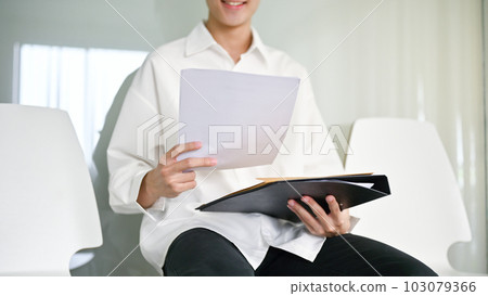 Close-up image of a young Asian male candidate sits in a waiting room 103079366