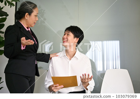 Kind senior Asian businesswoman is trying to comfort a candidate by talking before an interview 103079369