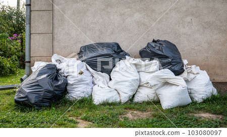 Construction debris in bags in a large pile. Repair and construction works Construction debris in bags in a large pile. Repair and construction works 103080097