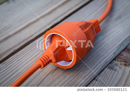 Electric wire, cable or extension cord on wood texture background 103080121