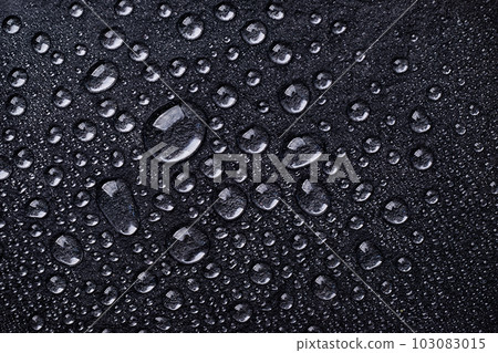 Water drops on black background top view. Black raindrops, abstract background. Water drops on black background top view. Black raindrops, abstract background. 103083015