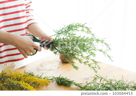 Photo of a woman making dried herbs 103084453