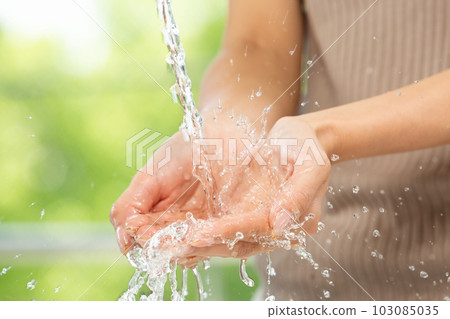 woman's hand bathing in water woman's hand bathing in water 103085035