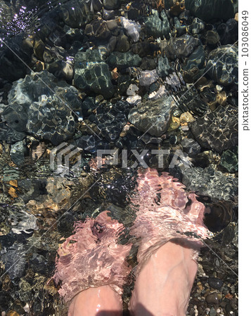 Feet under the sea. Foots immersed in water, stones under water. Mobile photography 103086049