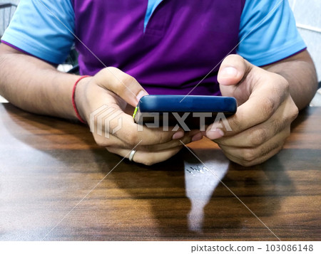 Man in casual form using mobile phone at the cafe 103086148
