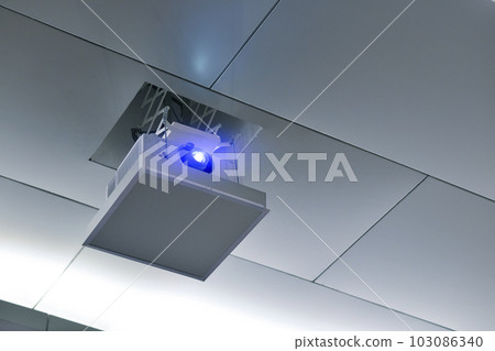 Projector on the ceiling in conference room. Projector on the ceiling in conference room. 103086340
