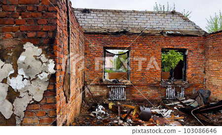A destroyed residential building in a Ukrainian village. A house without walls and a roof. War A destroyed residential building in a Ukrainian village. A house without walls and a roof. War 103086646