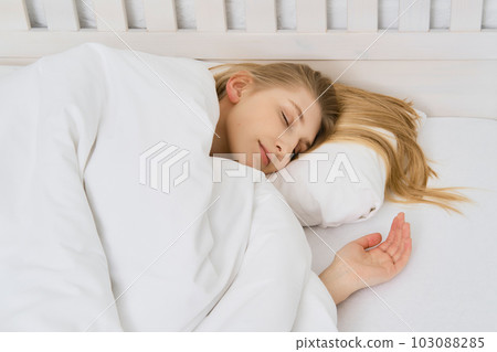 Young beautiful woman is napping in bedroom 103088285